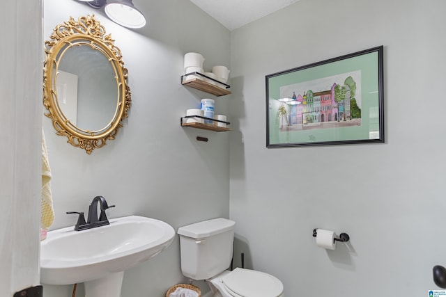 bathroom featuring sink and toilet