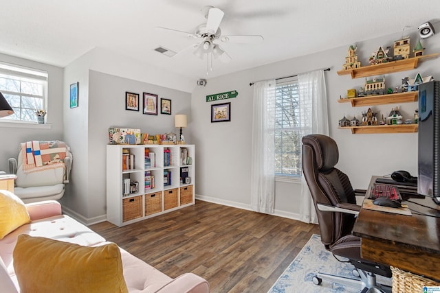 home office with dark hardwood / wood-style floors and ceiling fan