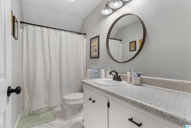 bathroom with vanity, toilet, and vaulted ceiling