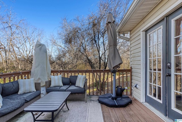 wooden terrace with french doors and an outdoor hangout area