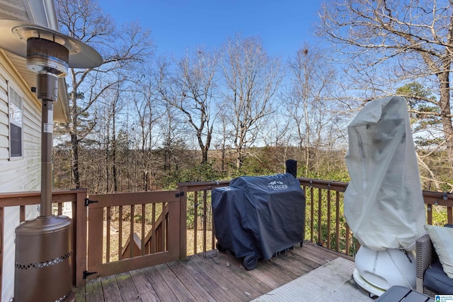 wooden terrace featuring area for grilling