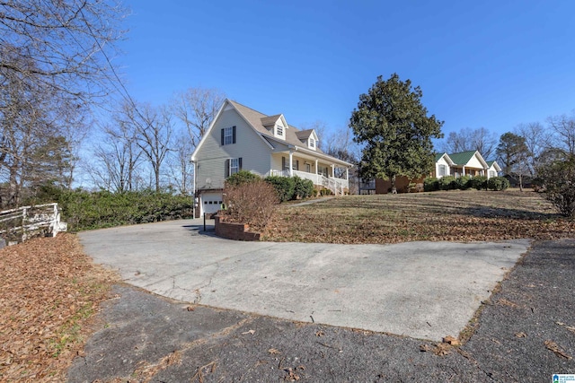 view of property exterior with a porch and a garage