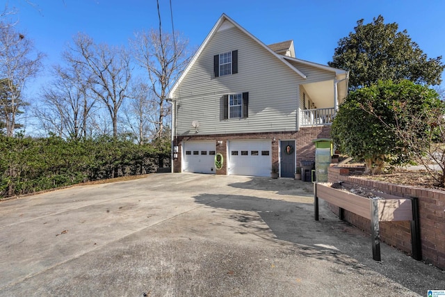 view of property exterior with a balcony and a garage