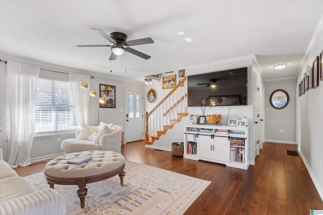 living room featuring a textured ceiling, dark hardwood / wood-style floors, ceiling fan, and crown molding