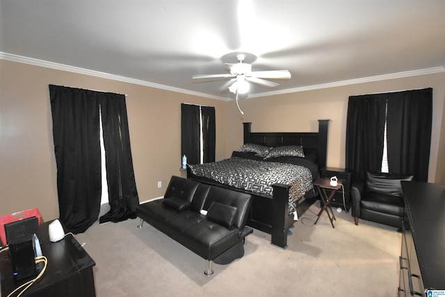 carpeted bedroom with ceiling fan and ornamental molding