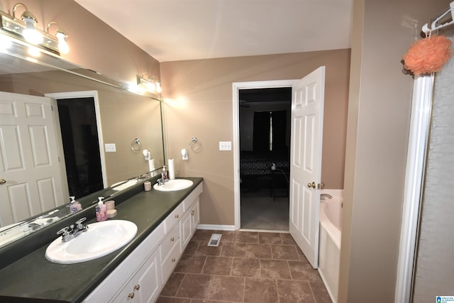 bathroom featuring vanity and a bath