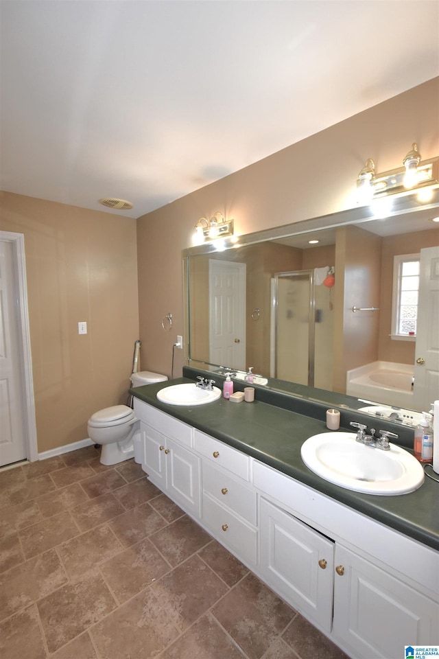 bathroom featuring vanity and independent shower and bath