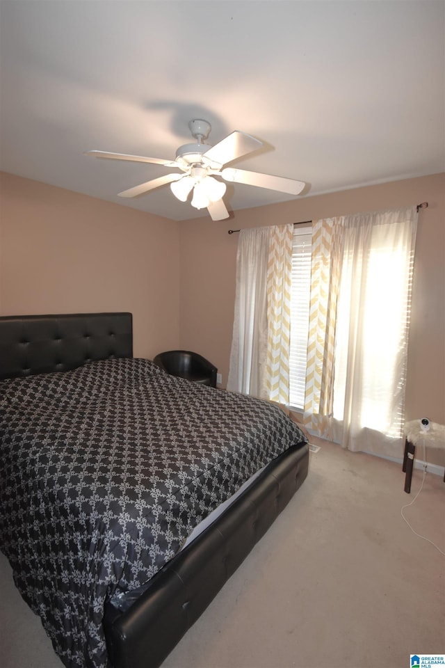 bedroom featuring light carpet and ceiling fan