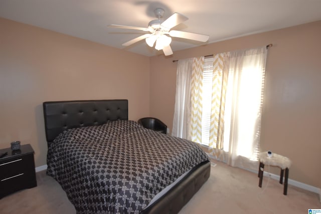 bedroom with light colored carpet and ceiling fan