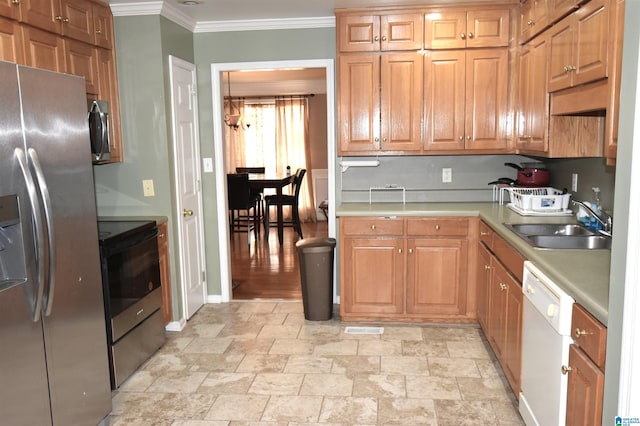 kitchen featuring crown molding, sink, and appliances with stainless steel finishes