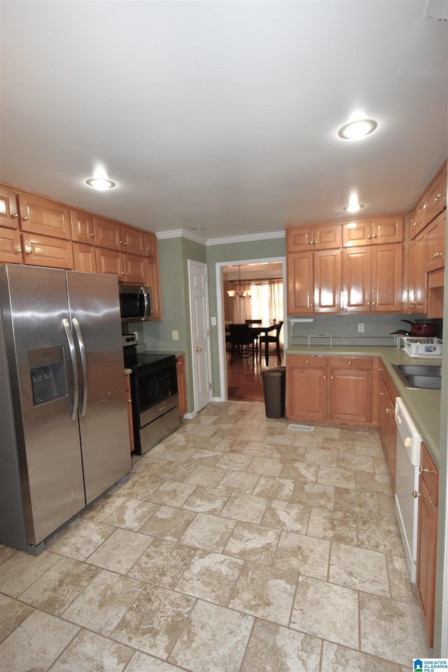 kitchen featuring sink, stainless steel appliances, and ornamental molding