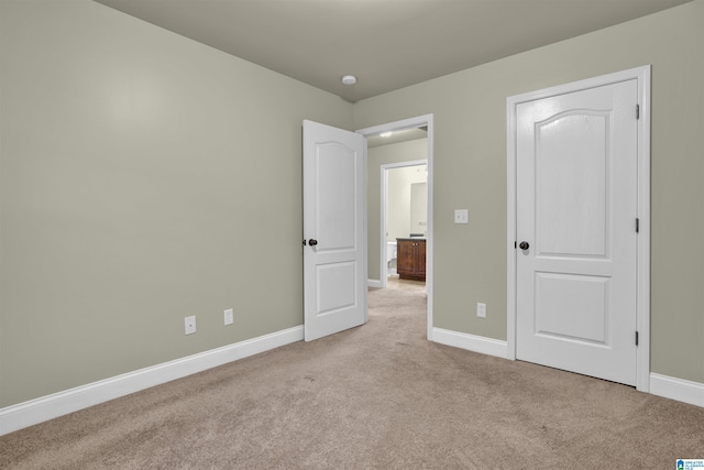 unfurnished bedroom with light carpet