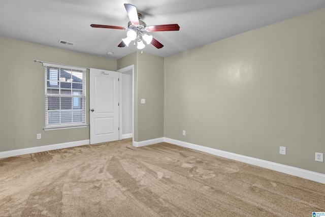 carpeted empty room featuring ceiling fan