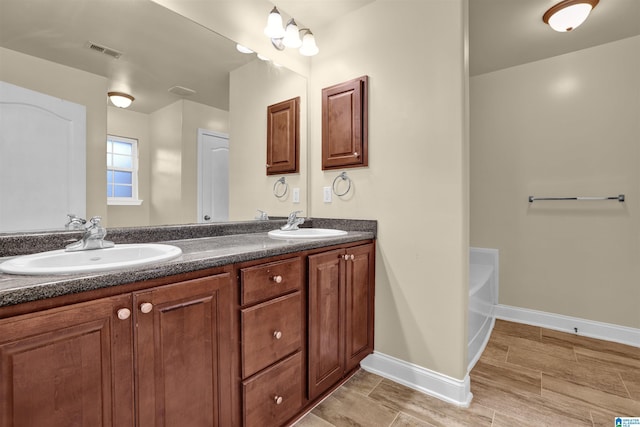 bathroom featuring vanity and a bathing tub