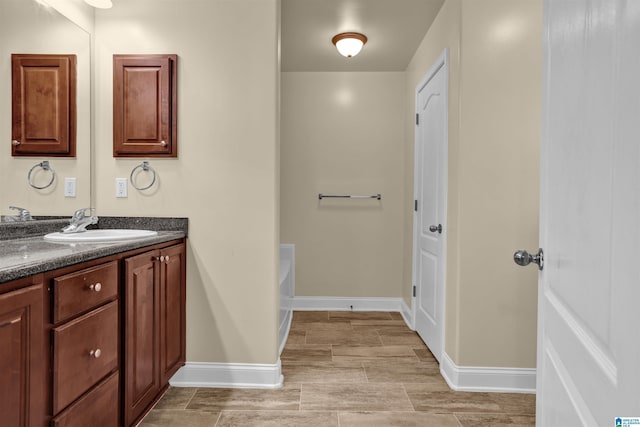 bathroom featuring vanity and a washtub