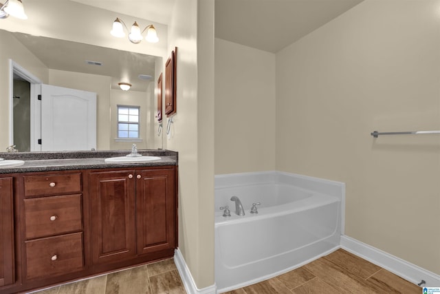 bathroom with a bathing tub and vanity