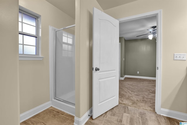 bathroom featuring ceiling fan, tile patterned flooring, and a shower with shower door