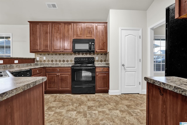 kitchen featuring backsplash and black appliances