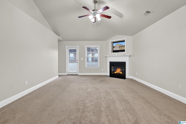 unfurnished living room featuring light colored carpet, vaulted ceiling, and ceiling fan