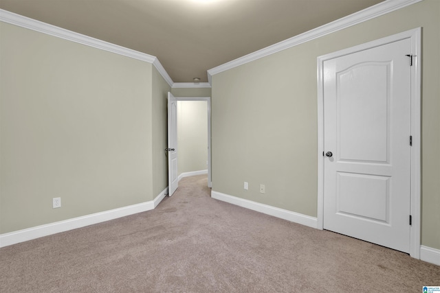 carpeted spare room with crown molding