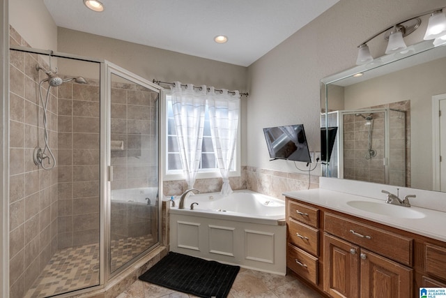 bathroom featuring shower with separate bathtub, vanity, and tile patterned floors