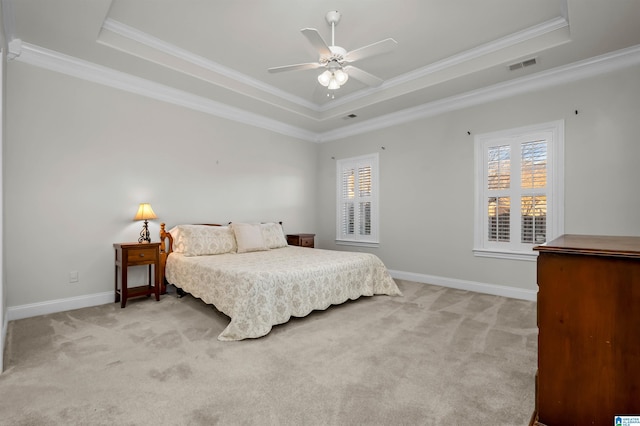 bedroom with ceiling fan, ornamental molding, and a tray ceiling