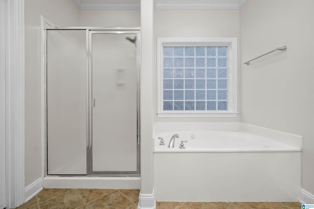 bathroom featuring ornamental molding and independent shower and bath