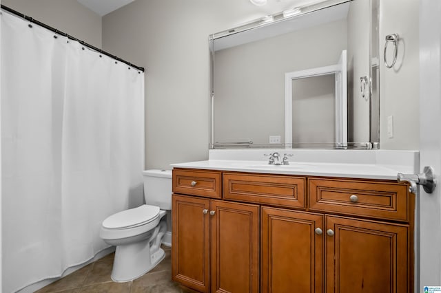 bathroom featuring tile patterned flooring, vanity, and toilet