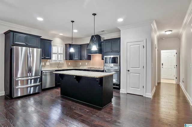 kitchen with hanging light fixtures, premium range hood, a kitchen island, a breakfast bar, and appliances with stainless steel finishes