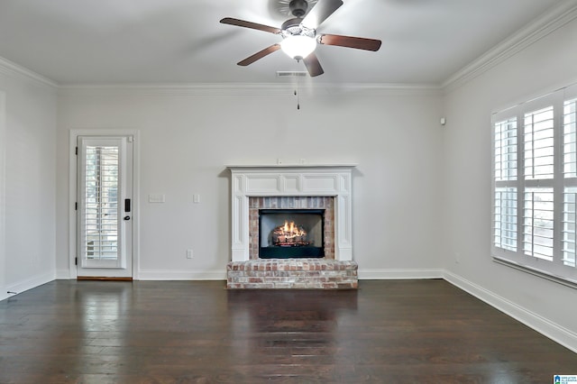 unfurnished living room featuring ornamental molding, ceiling fan, dark hardwood / wood-style flooring, and a brick fireplace