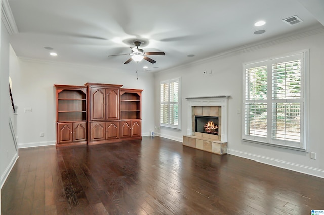 unfurnished living room with ornamental molding, ceiling fan, and a tile fireplace