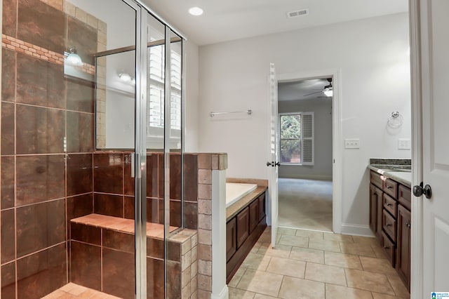 bathroom featuring a shower with door, vanity, tile patterned flooring, and ceiling fan