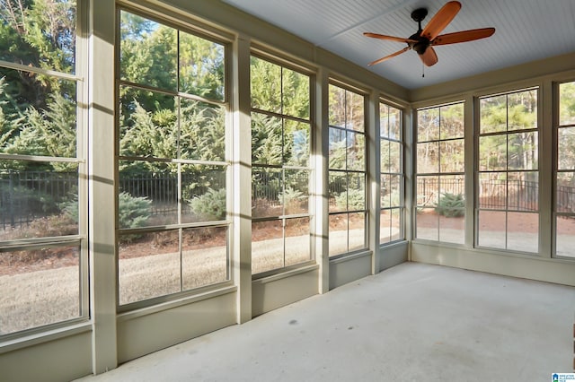 unfurnished sunroom with ceiling fan