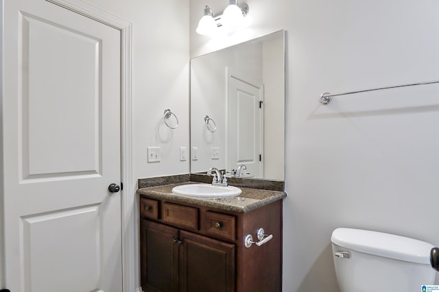 bathroom with toilet and vanity