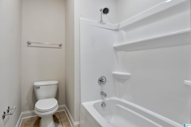 bathroom with tile patterned flooring,  shower combination, and toilet