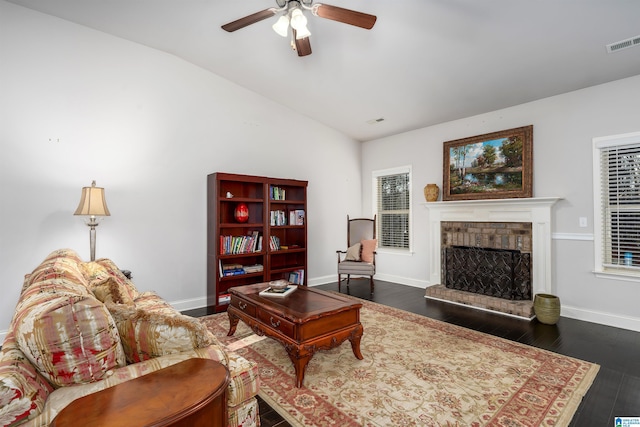 living room with ceiling fan, dark hardwood / wood-style flooring, and vaulted ceiling