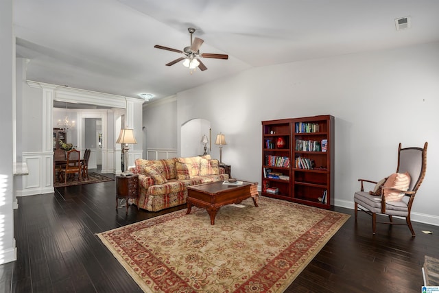 living room featuring lofted ceiling, dark hardwood / wood-style flooring, and ceiling fan with notable chandelier