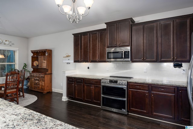 kitchen featuring backsplash, a chandelier, dark hardwood / wood-style flooring, and stainless steel appliances