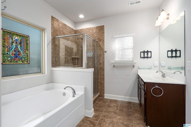 bathroom with shower with separate bathtub, vanity, and tile patterned floors