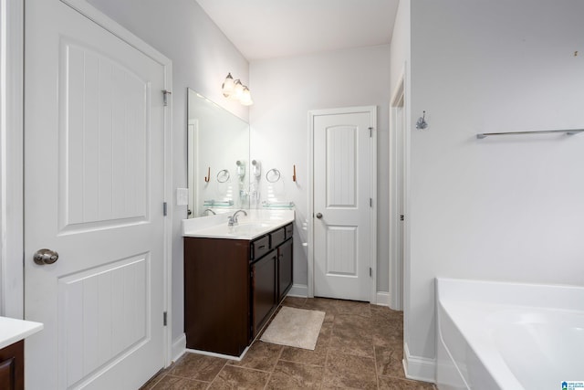 bathroom featuring a washtub and vanity