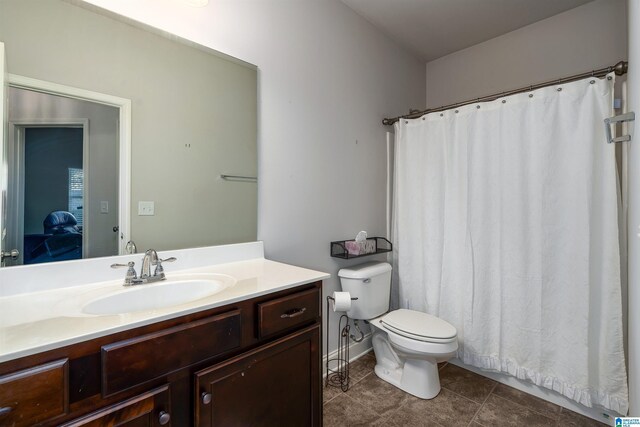 bathroom featuring tile patterned flooring, vanity, and toilet