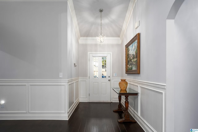 entrance foyer with crown molding, dark hardwood / wood-style floors, and an inviting chandelier