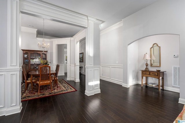 dining area with crown molding, a chandelier, and dark hardwood / wood-style floors