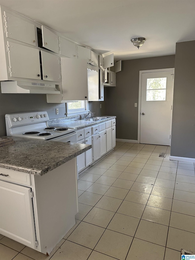 kitchen featuring white range with electric stovetop, sink, white cabinets, and light tile patterned floors