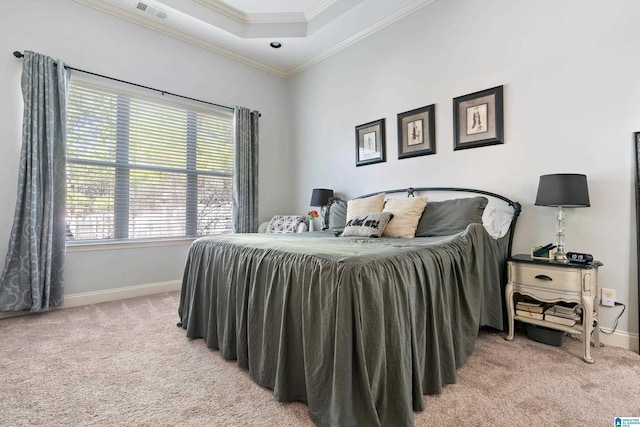 carpeted bedroom with a raised ceiling and ornamental molding