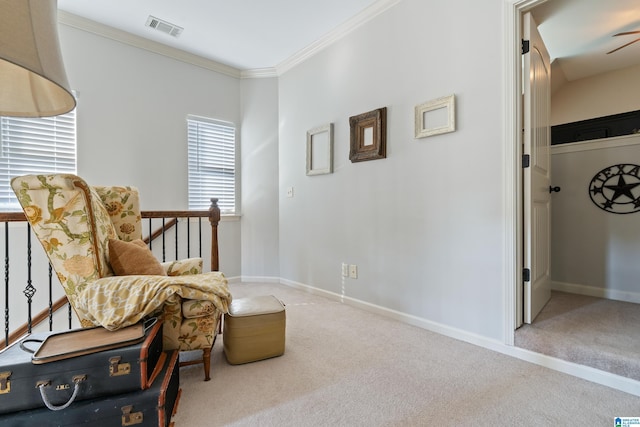 living area with carpet flooring, ceiling fan, and ornamental molding