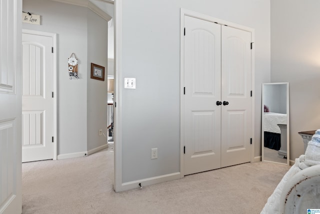 bedroom featuring a closet and light colored carpet