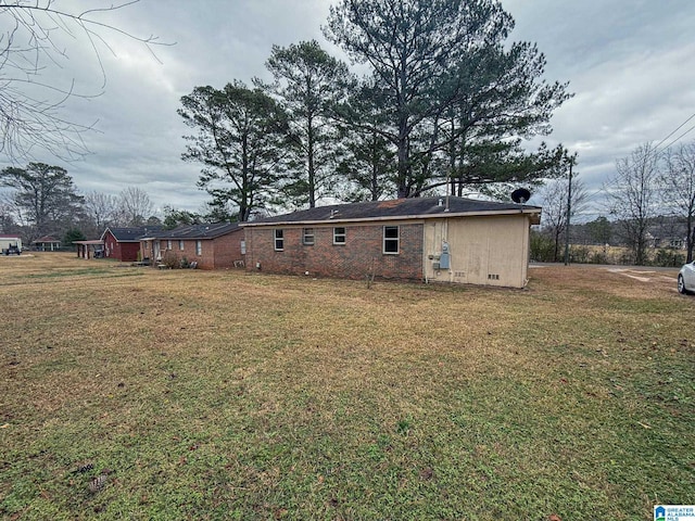 back of property featuring a lawn