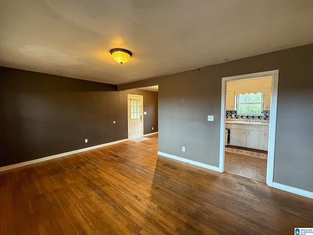 unfurnished room with hardwood / wood-style floors