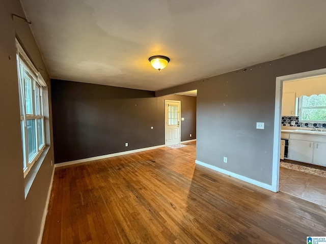 unfurnished room with wood-type flooring